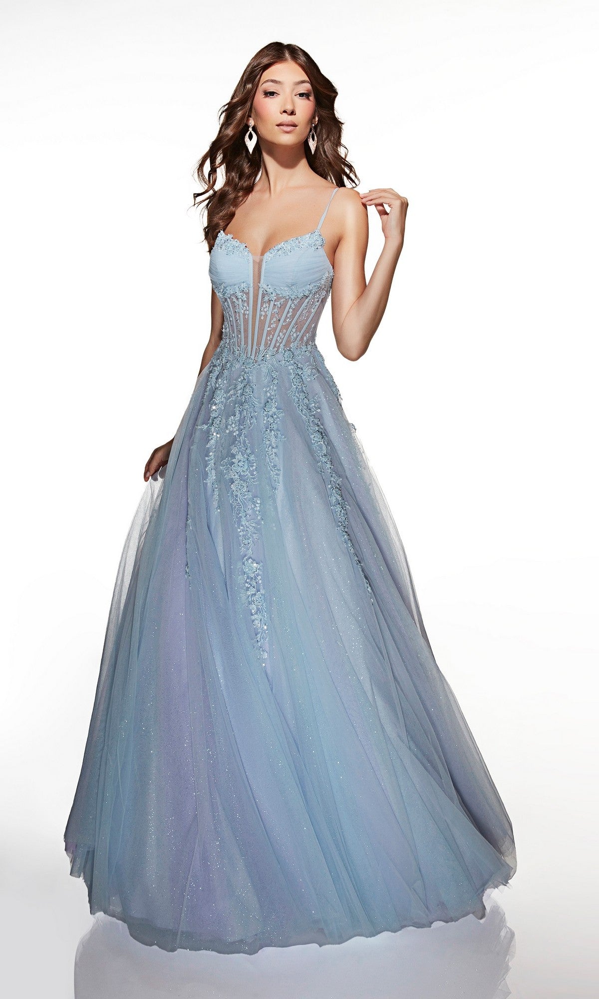A woman models the Alyce 62061 long prom dress—light blue, sleeveless, with floral appliques, a tulle ballgown skirt, and sheer lace corset bodice—against a white background.